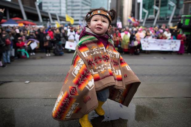Maelona Williams, 1, attends a Women's March with her father in Vancouver on Jan. 20, 2018.