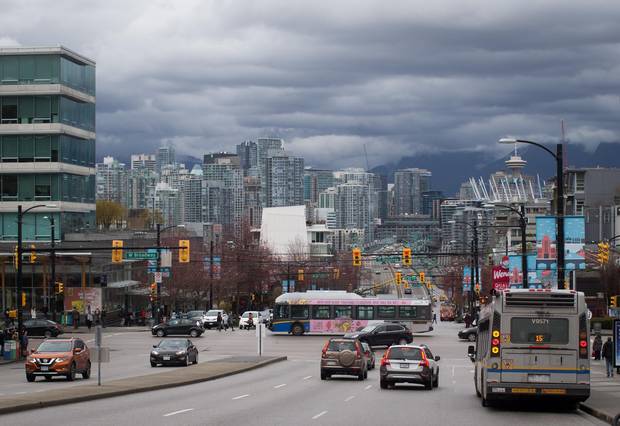 A TransLink bus travels on West Broadway in Vancouver.