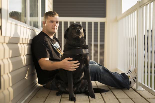 Joe Rustenburg with his service dog Vixin. Mr. Rustenburg served two tours in Afghanistan and is vocal about his struggles with mental-health.