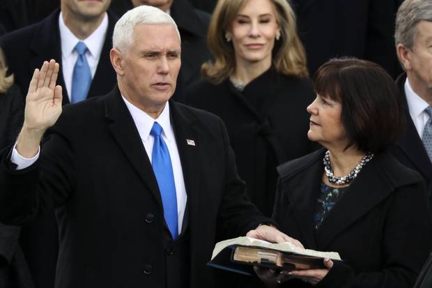 Vice President Mike Pence is sworn in as his wife, Karen, holds the Bible.