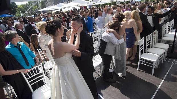 Dayna Murphy, left, and her partner, Shannon St. Germain, dance after getting married during a mass LGBTQ wedding at Casa Loma in June 2014.