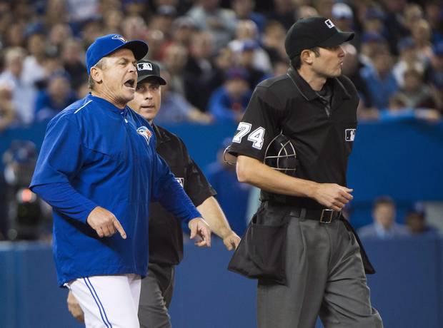 Toronto Blue Jays manager John Gibbons, left, argues with home plate umpire John Tumpane, right, during seventh inning AL baseball action in Toronto on Wednesday, April 27, 2016. Gibbons was ejected from the game.