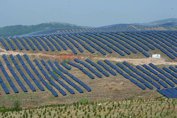 Solar panels on hills in Chaohu, in China’s Anhui Province. The cost of solar cells has now come very close to a threshold where it is cheaper to generate solar electricity than coal, even without government subsidies.