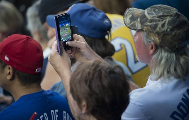 Top photo: Small cells, like those above the nosebleed section of the Rogers Centre, will play a key role in reliable 5G coverage. Bottom photo: Fans take in a Blue Jays game on September of 2017.