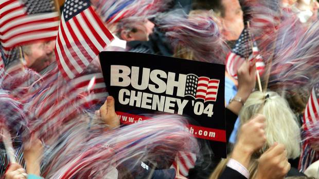 Bush supporters wave American flags at the Ronald Reagan Building in Washington, D.C., on Nov. 3, 2004, as Democrat John Kerry concedes the election in a speech from Boston.