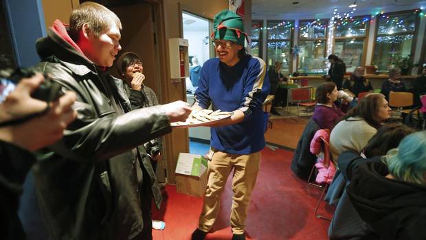 Tony Niiganii, coordinator for the North End Youth Council and facilitator for the North End Youth Skills Development Strategy, hands out cookies baked by youth in his program.