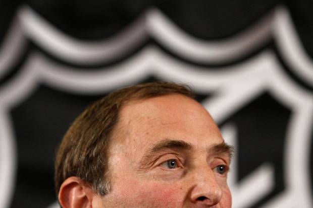 The NHL logo looms behind league commissioner Gary Bettman.