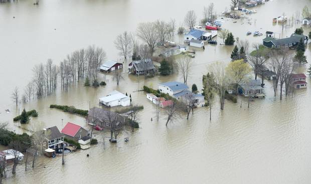 Flooded homes are seen on Monday, May 8, 2017 in Rigaud, Que., west of Montreal. 