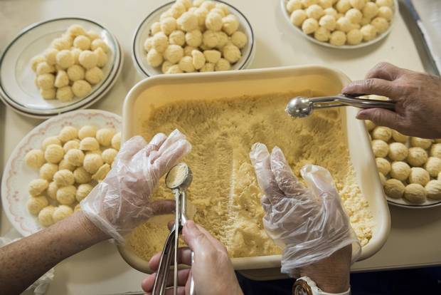 Cheese-and-potato perogy filling is balled as part of the preparation process.