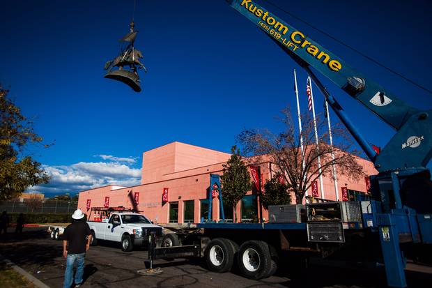 Workers remove a statue depicting two Confederate soldiers one of whom holds the Confederate battle flag, from the campus of Dixie State College on Wednesday, Dec. 6, 2012.