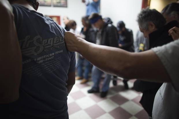 Members of the Dudes Club form a circle as they conclude a meeting in Vancouver’s Downtown Eastside in October 2015.