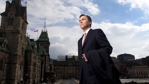 Finance Minister Bill Morneau stands on the front step of Parliament Hill on March 17.