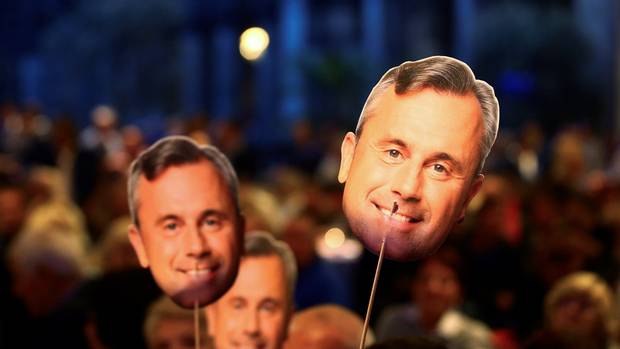 Hofer supporters hold masks with his face on them during the ‘FPOe Summer Party’ in Vienna on Sept. 6, 2016.