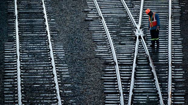 A Canadian Pacific Rail worker inspects tracks at the company's Port Coquitlam yard east of Vancouver, B.C.