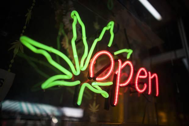 An open sign is seen outside Hot Box Cafe before a meeting attended by members of the Toronto cannabis industry put on by the Cannabis Friendly Business Association in Toronto, Tues. May 17, 2016.