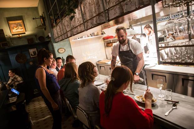 Chef J.C. Poirier talks with diners sitting at the open kitchen at St. Lawrence.