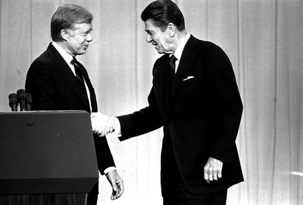 President Jimmy Carter, left, and Republican presidential candidate Ronald Reagan, shake hands before nationwide televised debate in Oct. 1980 in Cleveland, Ohio.