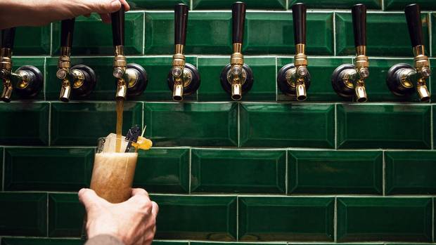 General manager Robin Kemp pours a rye and ginger from a tap at Maple Leaf Tavern in Toronto on June 23, 2016.