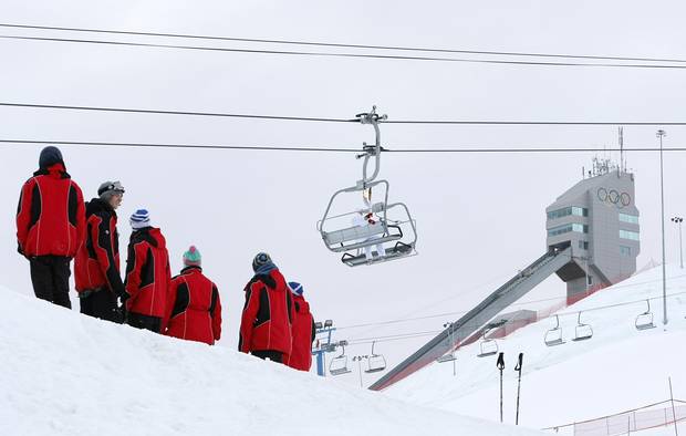Canada Olympic Park Torchbearer and Winsport employee Stuart McDonough carries the Olympic flame up the ski lift at the Canada Olympic Park in Calgary in the lead-up to the Vancouver 2010 Olympics