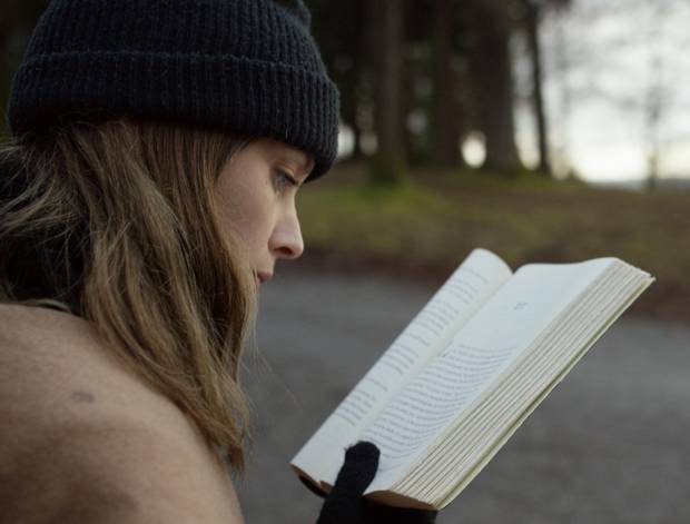 A scene in Mark Lewis’s film, Canada, tracks a young woman reading the 2012 book Canada, by Richard Ford. 