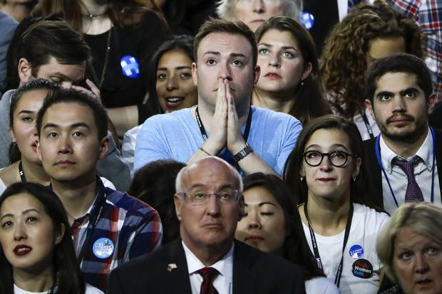 Guests at Democratic presidential nominee Hillary Clinton's election night rally watch the big screen television at the Jacob Javits Center glass enclosed lobby in New York.