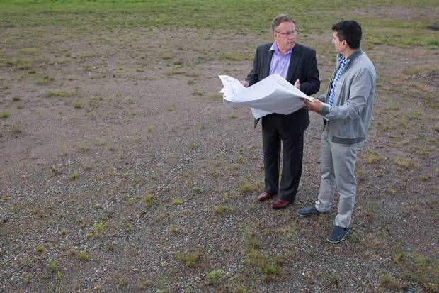 Concered about drug costs at Essar Steel Algoma, Jim Rennie (left) hit upon the idea of building an employer-owned pharmacy. Here he looks over blueprints with developer Joe Ruscio.