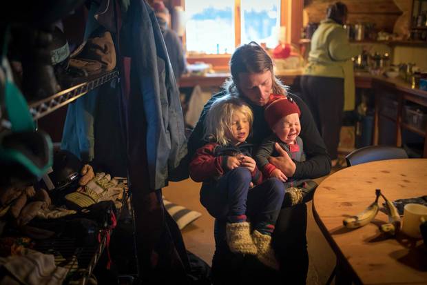Dave Treadway holds his sons Kasper, left, and Raffi at Tweedsmuir Ski Club’s backcountry cabin. 