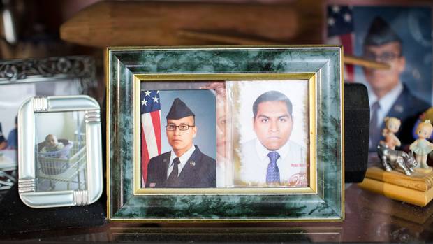 A picture of Agustin Meza, right, is shown beside his younger brother, Raymond Quintero, who is a U.S. soldier.
