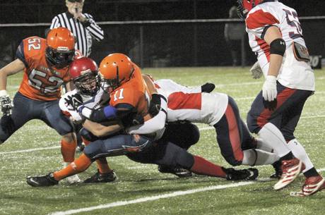 L’Odyssée running back Jérémie Maillet is tackled by Tantramar's MacKenzie Beal and Jory Parsons. L’Odyssée forfeited the game 35-0 after numerous injuries to their players. 