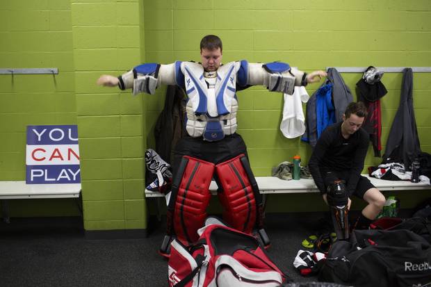 Goalie Joel Danyluk gets dressed before the game.