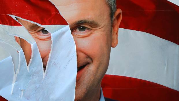 A presidential election campaign poster of Norbert Hofer lies torn in Vienna on Sept. 7. Austrians are re-running their presidential election next month.