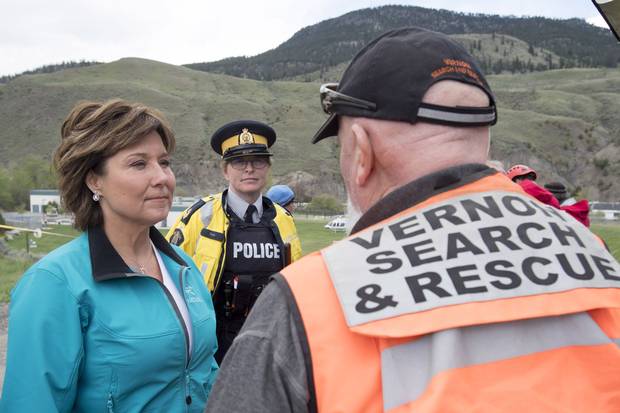 B.C. Premier Christy Clark speaks to a rescue worker as she visits Cache Creek, B.C., on May 6, 2017.