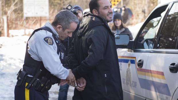 A refugee claimant from Syria is arrested after crossing the border into Canada from the United States Monday, February 20, 2017 near Hemmingford, Que.