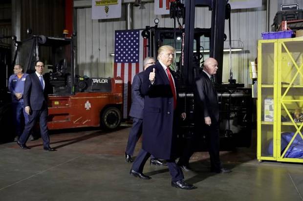President Donald Trump takes tour of H&K Equipment Company with owners Peter Cicero and George Koch, right, during a visit to promote his tax and economic plan, Thursday, Jan. 18, 2018, in Coraopolis, Pa. Treasury Secretary Steven Mnuchin follows at far left