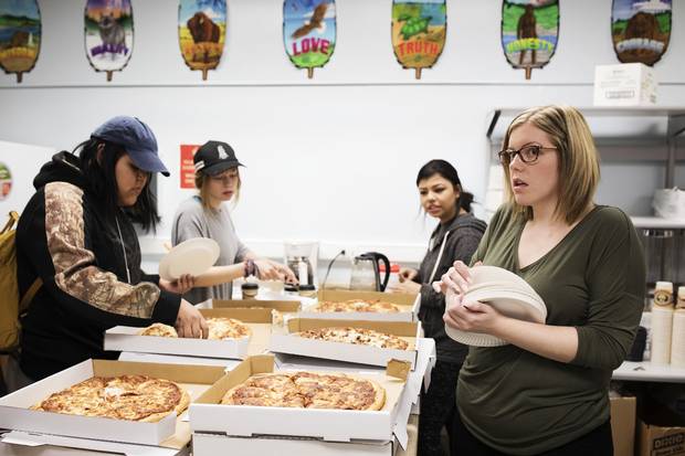 Kieran McMonagle distributes paper plates to students at lunch hour. Most of the students don't bring lunches to school with them, so food is often supplied.
