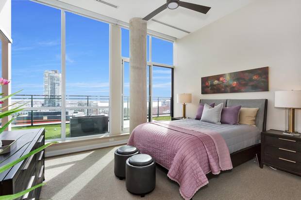 The master bedroom has floor-to-ceiling windows.
