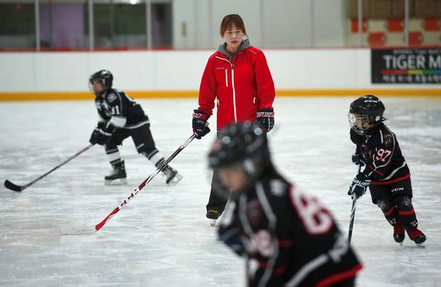 Hwangbo Young teaches a hockey class for children at an ice rink in Seoul, April 4, 2017.