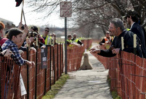 A Trump supporter, right, argues with a protester outside a campaign rally for Republican U.S. presidential candidate Donald Trump in Janesville, Wisconsin.