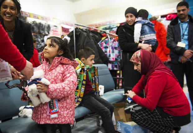 Syrian refugees get new winter clothing at Pearson International Airport in Toronto Feb. 29, 2016.