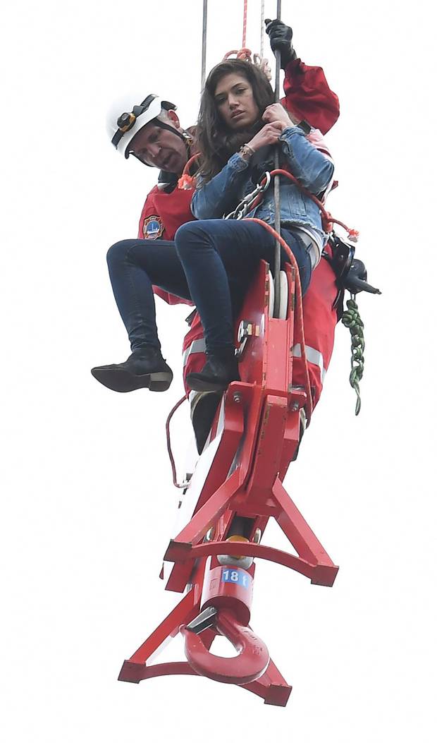 A woman is rescued from a downtown Toronto crane early on April 26, 2017.