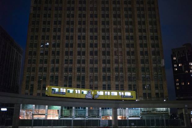The People Mover passes an abandoned high rise in downtown Detroit.