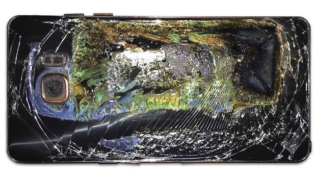 A damaged Samsung Galaxy Note 7 is seen on a table in Richmond, Va., after it caught fire on Sunday, Oct. 9.