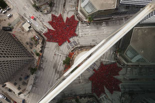 July 1, 2017: Winipeggers assemble into a ‘living leaf’ at Portage and Main.
