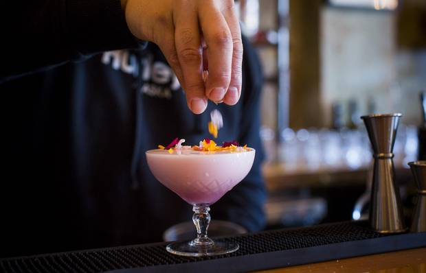 A bartender creates the Lady Wallflower cocktail.
