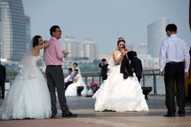 Chinese couples gather for a wedding photo shoot at the West Bund in Shanghai on Sept. 25, 2014.