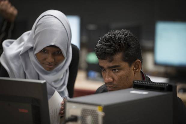 Ali Johar, right, gets some help from peer tutor Naime Mukhtar at Eastwood Collegiate Institute in Kitchener, Ont. in early November.