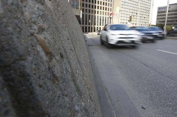 High concrete barriers and multiple turning lanes of traffic deter pedestrians from crossing the road on foot.