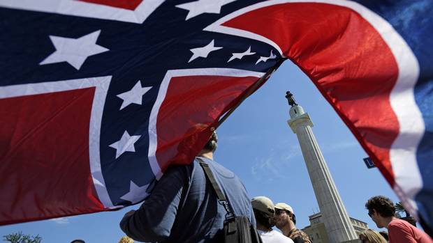 Protesters calling for the removal and the preservation of Confederate-era monuments face off in dueling demonstrations, Sunday, May 7, 2017, in New Orleans.