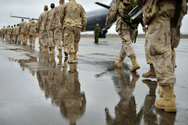 Canadian Armed Forces members board a CC-150 Polaris aircraft in 14 Wing Greenwood, Nova Scotia in support of Operation IMPACT on October 23, 2014.