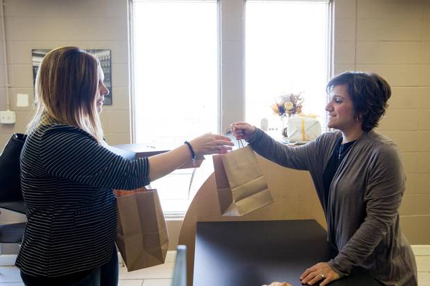 Owner Carla Roppo-Owczarek, right, serves a customer at Canova.